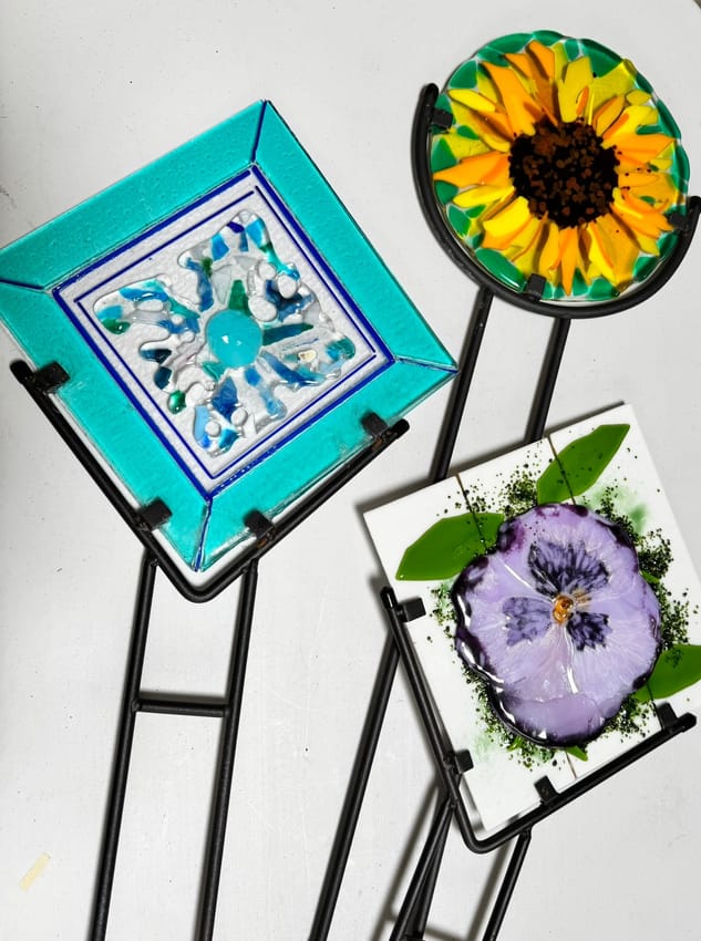 Fused-glass garden stakes: sunflower, pansy and an abstract tile