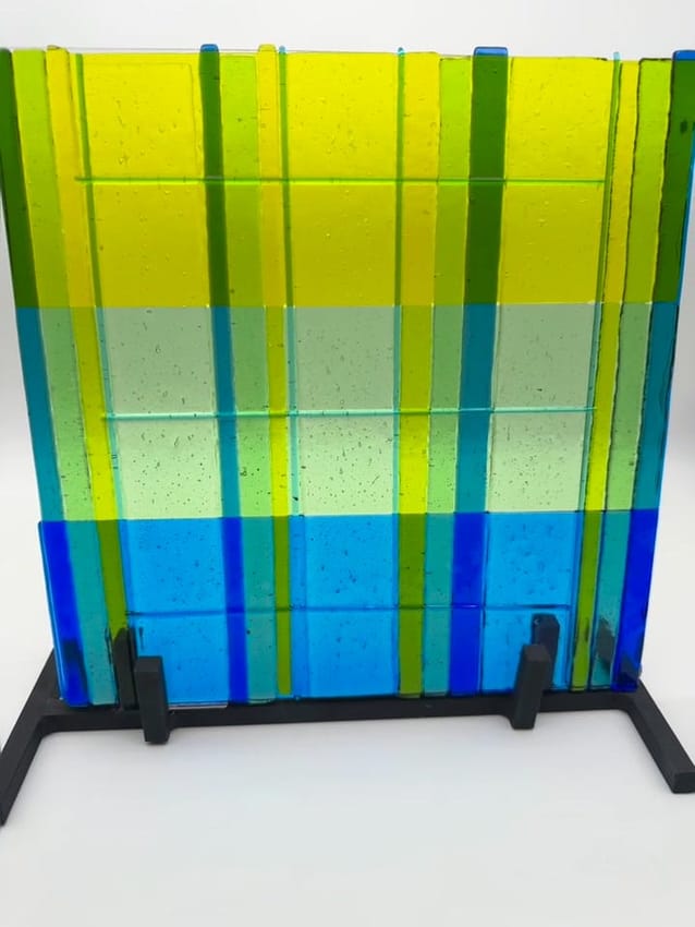 Woven glass panel in yellow, green and blue strips